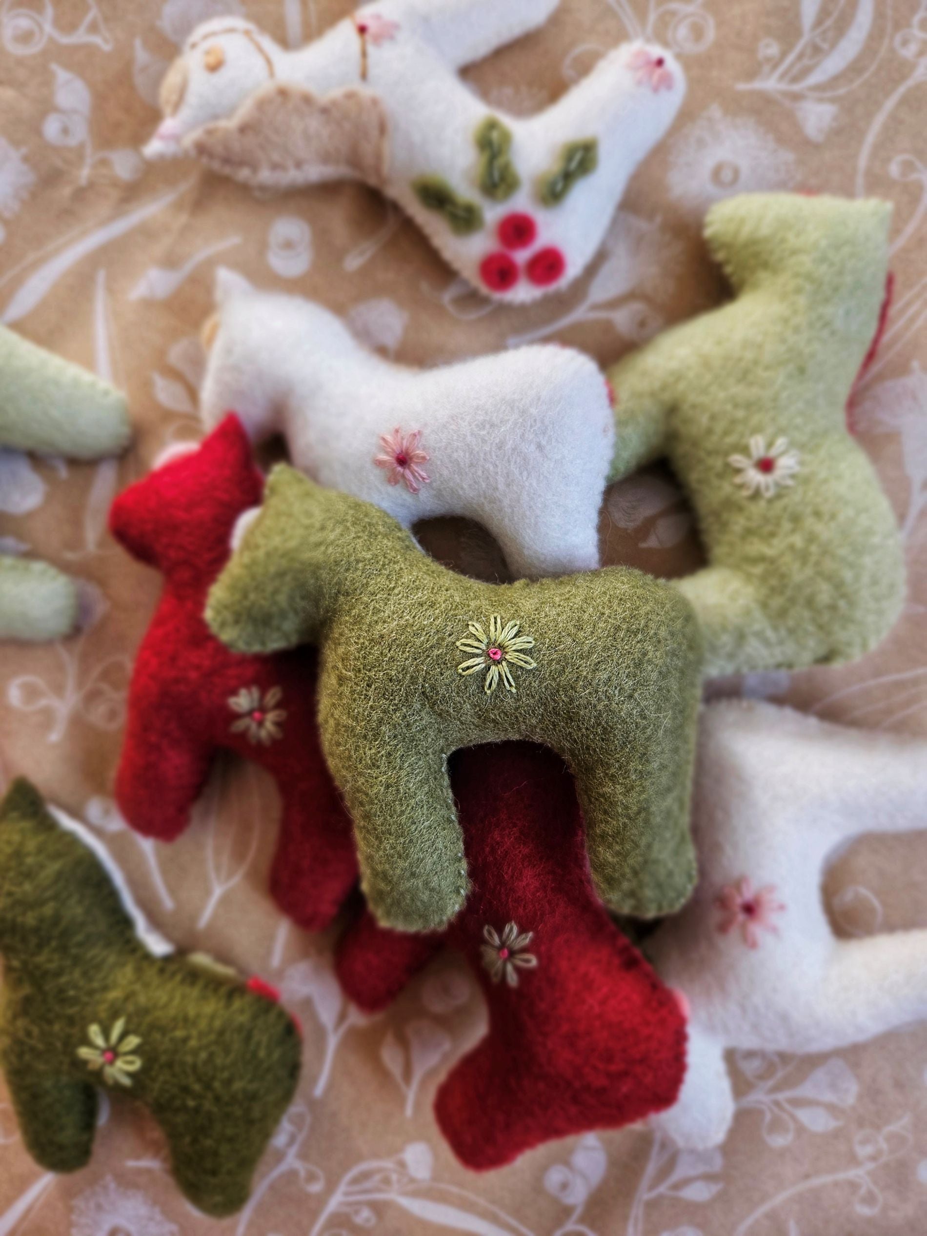 Decorative felt animals on a textured fabric background