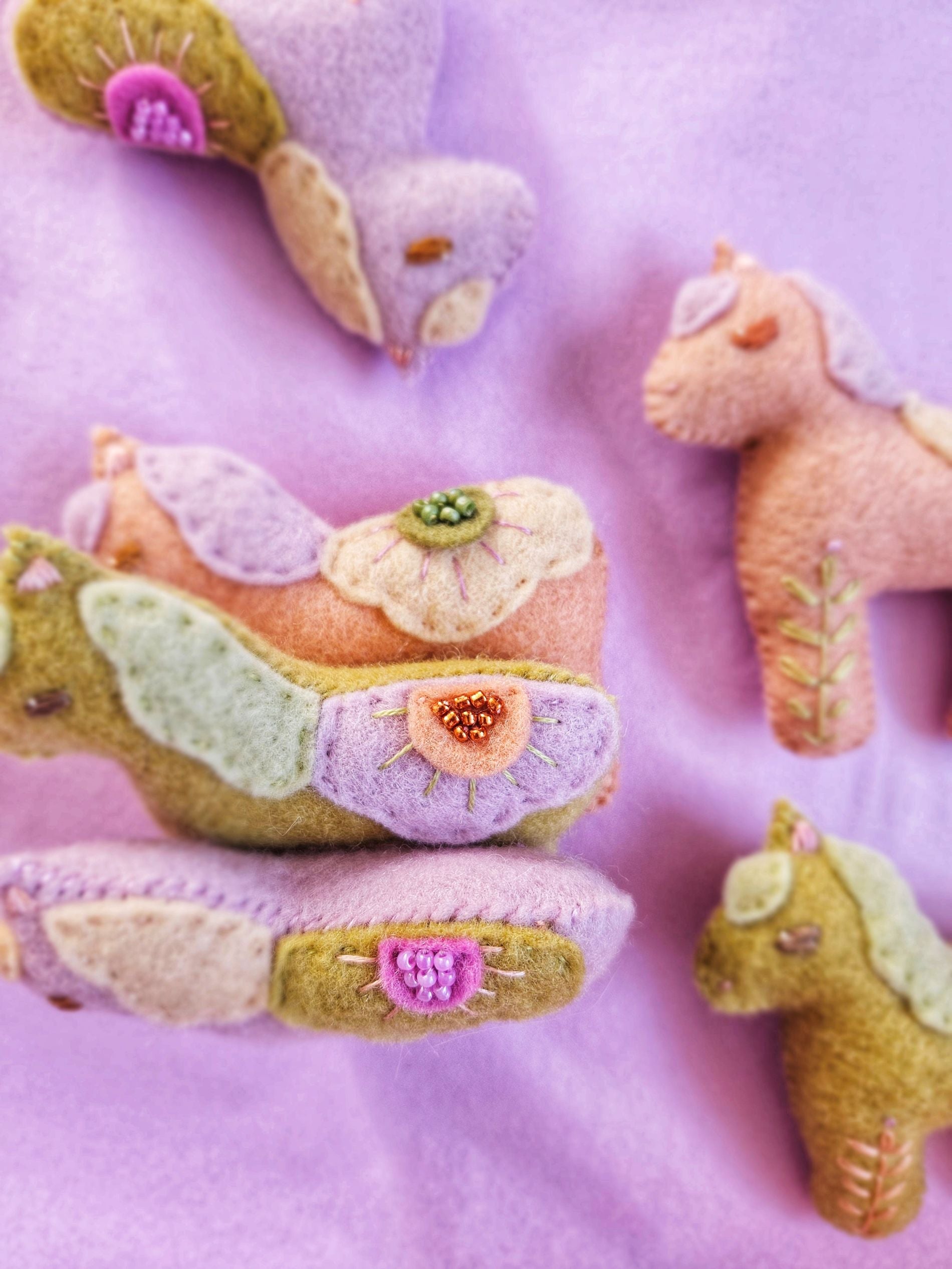 Felt animal toys on a purple background