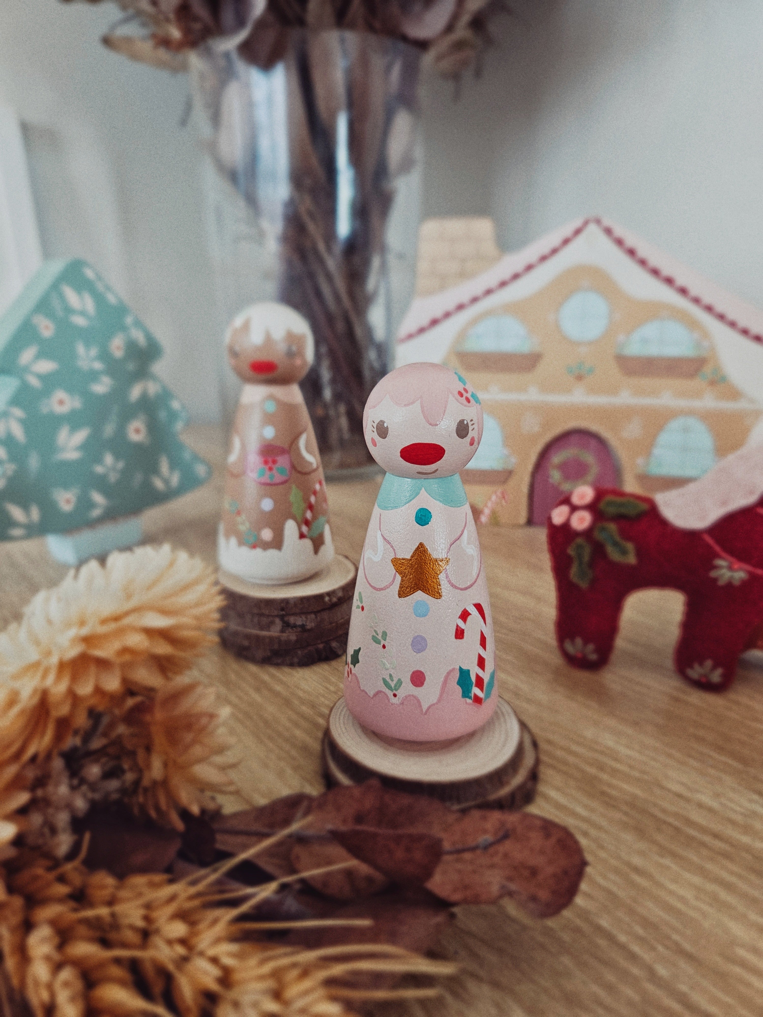Decorative wooden toys on a wooden surface with a blurred background